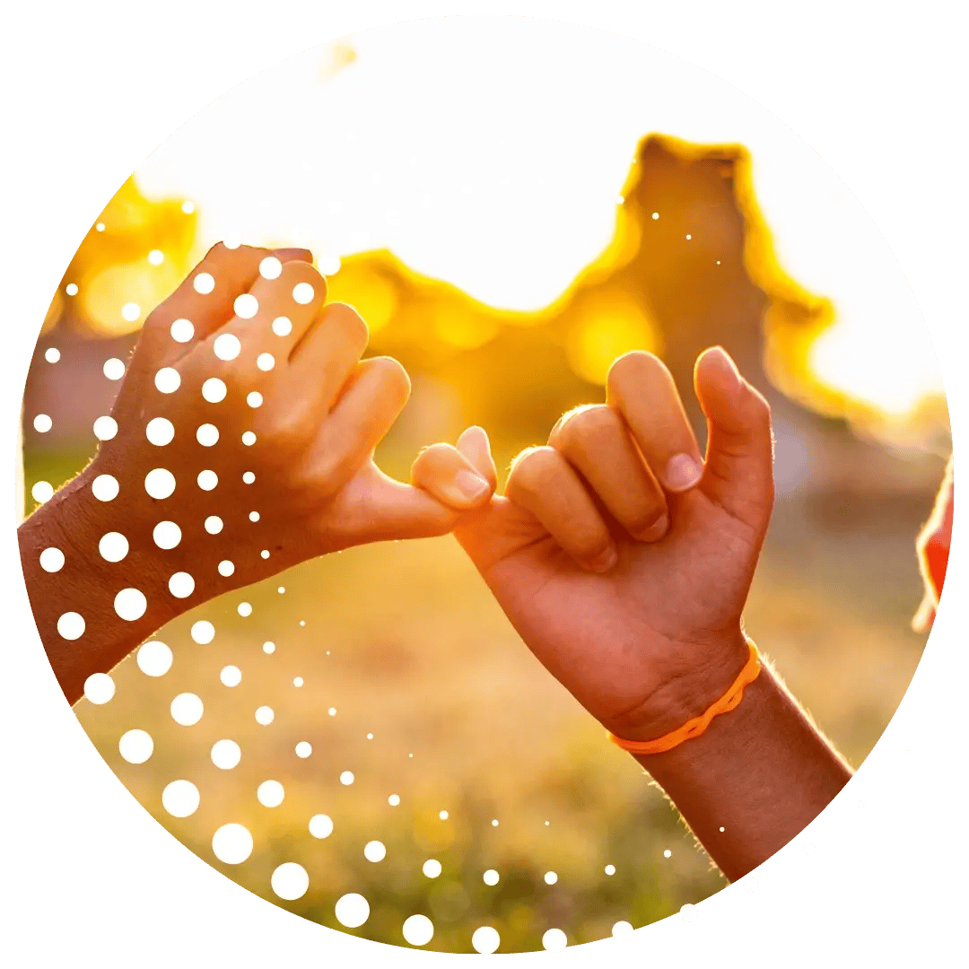 To people's hands with fingers linked symbolising unison and connection